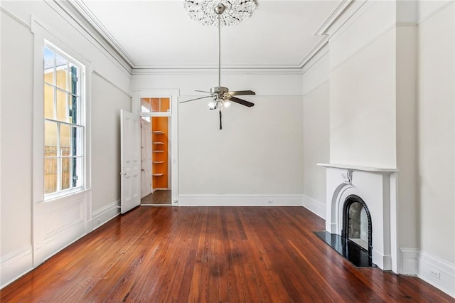 101012 Philip St, New Orleans, LA 70130 - unfurnished living room featuring wood-type flooring, a fireplace with raised hearth, ornamental molding, a ceiling fan, and baseboards