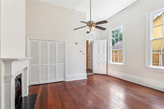 101012 Philip St, New Orleans, LA 70130 - unfurnished living room with a ceiling fan, hardwood / wood-style floors, baseboards, and a fireplace