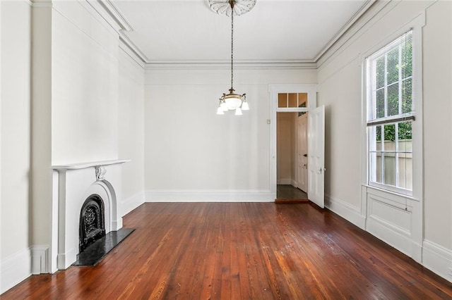 101012 Philip St, New Orleans, LA 70130 - unfurnished living room featuring a chandelier, hardwood / wood-style floors, a fireplace with raised hearth, and crown molding