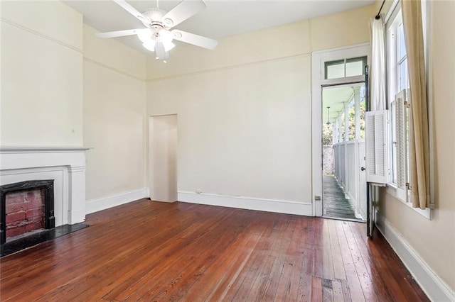 101012 Philip St, New Orleans, LA 70130 - unfurnished living room with dark wood-type flooring, ceiling fan, and baseboards