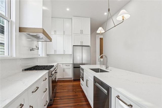 2623 Dauphine St, New Orleans, LA 70117 - kitchen featuring appliances with stainless steel finishes, custom range hood, white cabinets, dark wood finished floors, and recessed lighting