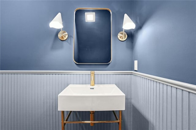 2623 Dauphine St, New Orleans, LA 70117 - bathroom with a sink and a wainscoted wall