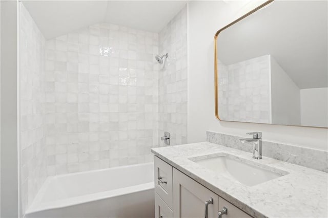 2623 Dauphine St, New Orleans, LA 70117 - bathroom with vanity, washtub / shower combination, and vaulted ceiling
