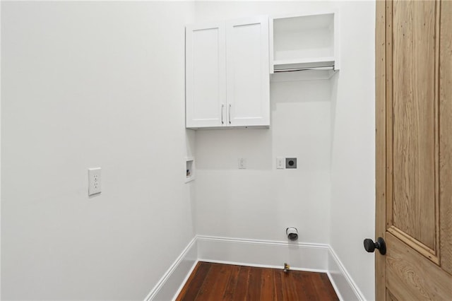 2623 Dauphine St, New Orleans, LA 70117 - washroom with washer hookup, cabinet space, electric dryer hookup, dark wood-style flooring, and hookup for a gas dryer