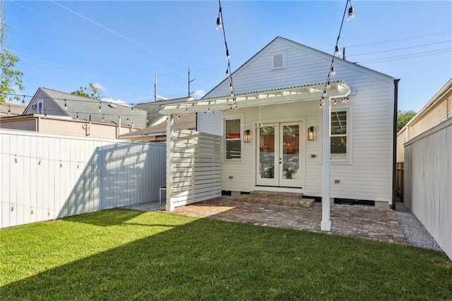 2623 Dauphine St, New Orleans, LA 70117 - rear view of house featuring french doors and a fenced backyard