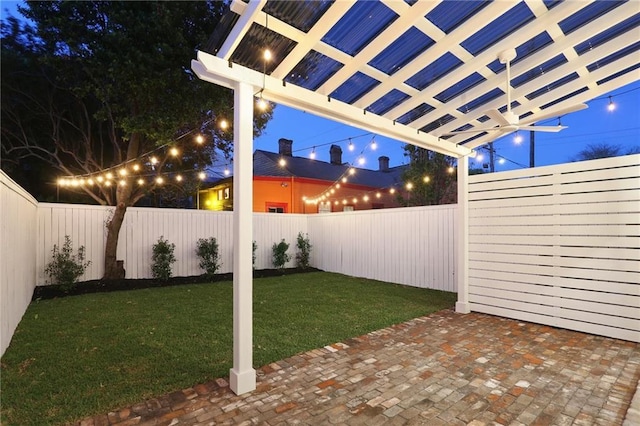 2623 Dauphine St, New Orleans, LA 70117 - yard at twilight with a fenced backyard, a patio area, and a pergola