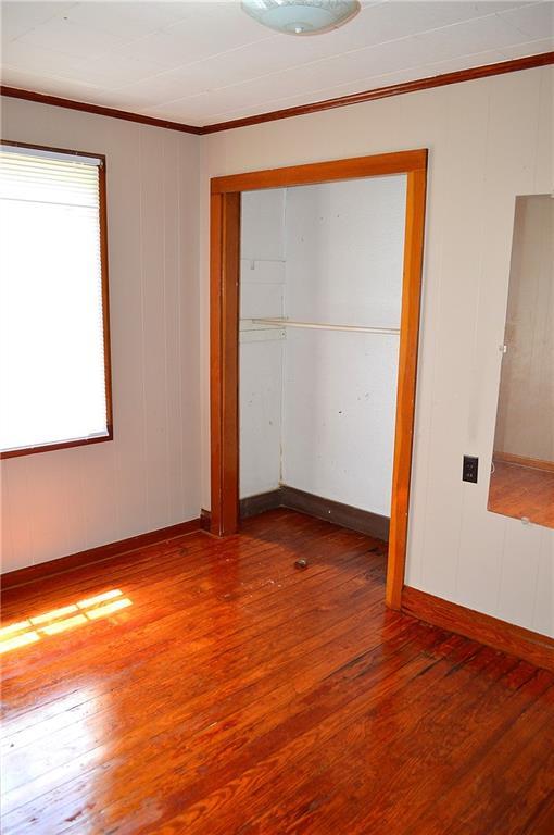 607 Central Ave, Westwego, LA 70094 - spare room with wood finished floors, baseboards, and ornamental molding