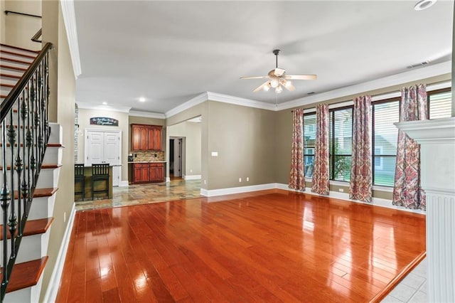 unfurnished living room with baseboards, recessed lighting, a ceiling fan, stairs, and hardwood / wood-style flooring