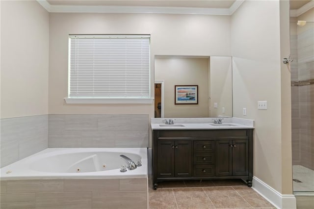 bathroom featuring a tub with jets, crown molding, a shower stall, double vanity, and tile patterned floors