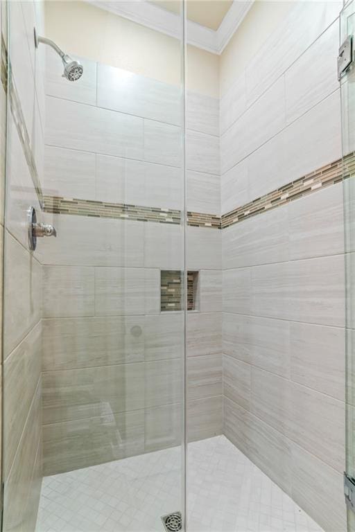 full bath with a stall shower and ornamental molding
