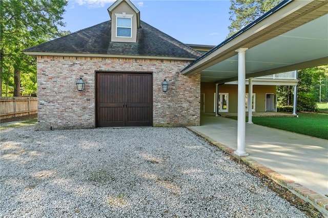 view of front of house featuring brick siding and fence