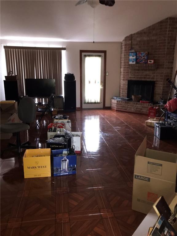 219 Queen Anne Dr, Slidell, LA 70460 - living room featuring ceiling fan, vaulted ceiling, and a fireplace