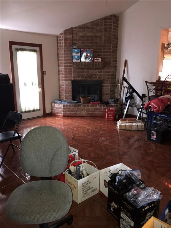 219 Queen Anne Dr, Slidell, LA 70460 - living room with a fireplace and lofted ceiling