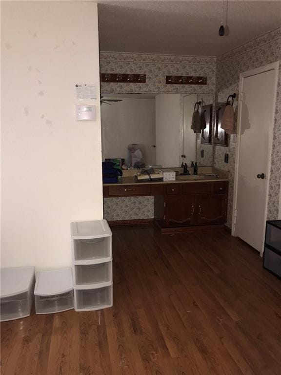 219 Queen Anne Dr, Slidell, LA 70460 - bathroom with vanity, wallpapered walls, and wood finished floors