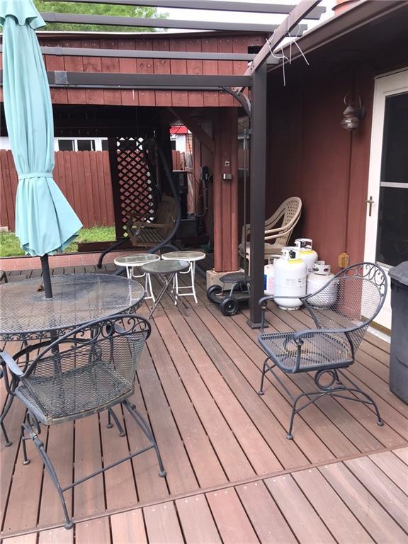 219 Queen Anne Dr, Slidell, LA 70460 - wooden deck with outdoor dining space and a pergola