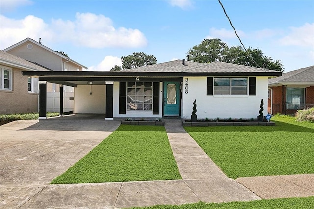 3408 Lake Villa Dr, Metairie, LA 70002 - view of front of property with a carport, a front yard, concrete driveway, and a shingled roof