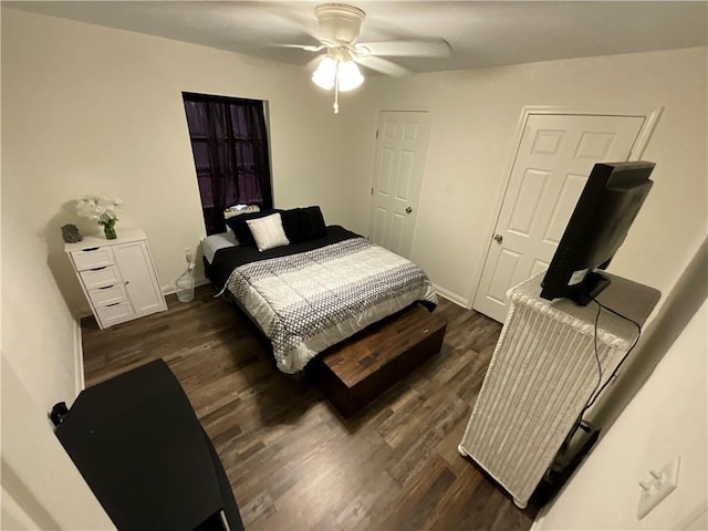 420 Michigan Ave, Slidell, LA 70458 - bedroom with dark wood-style flooring, ceiling fan, and baseboards