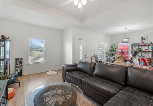 10735 Vienna St, New Orleans, LA 70126 - living area featuring ornamental molding, a raised ceiling, wood finished floors, and a ceiling fan