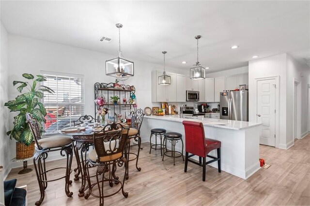 10735 Vienna St, New Orleans, LA 70126 - kitchen with a peninsula, appliances with stainless steel finishes, light wood finished floors, and recessed lighting