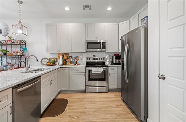 10735 Vienna St, New Orleans, LA 70126 - kitchen featuring visible vents, recessed lighting, appliances with stainless steel finishes, light stone counters, and a sink