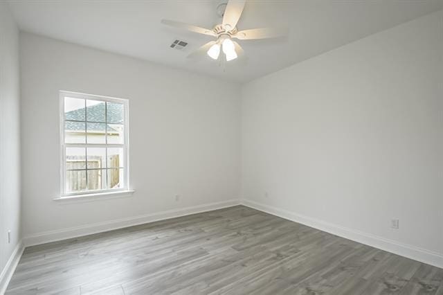 10735 Vienna St, New Orleans, LA 70126 - empty room with wood finished floors, baseboards, a ceiling fan, and visible vents