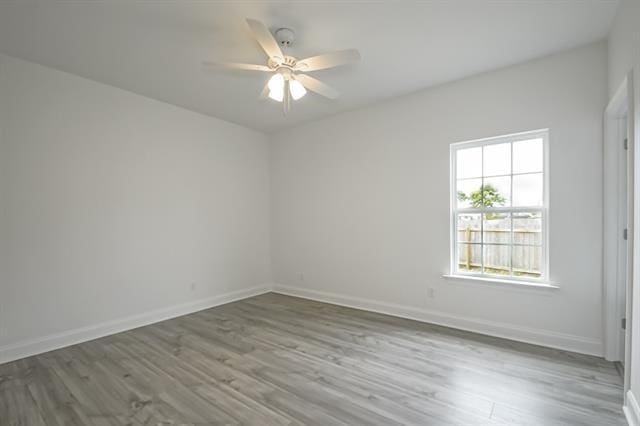 10735 Vienna St, New Orleans, LA 70126 - unfurnished room featuring baseboards, a ceiling fan, and wood finished floors