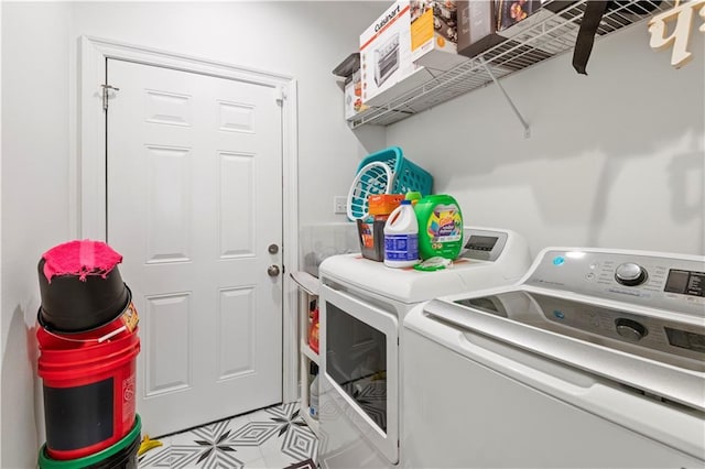 10735 Vienna St, New Orleans, LA 70126 - washroom featuring washing machine and clothes dryer, light tile patterned flooring, and laundry area