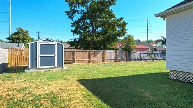 10735 Vienna St, New Orleans, LA 70126 - view of yard featuring a storage shed, a fenced backyard, and an outdoor structure
