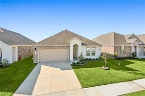 ranch-style house with an attached garage, concrete driveway, and a front yard