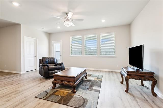 living room featuring baseboards, a ceiling fan, recessed lighting, and wood finished floors