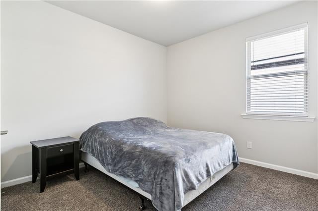 carpeted bedroom featuring baseboards
