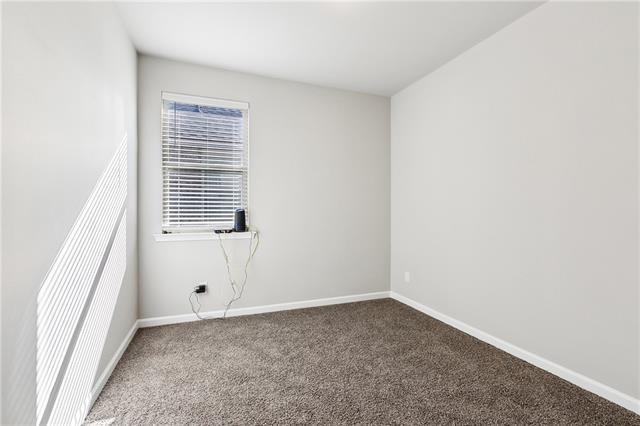empty room featuring baseboards and carpet