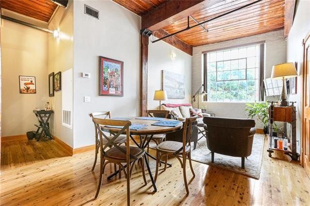 living area with wood-type flooring, visible vents, wood ceiling, and beam ceiling