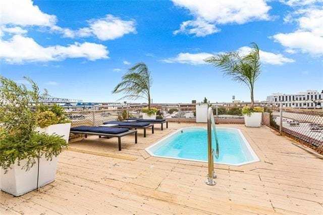 view of pool with a deck and a fenced in pool