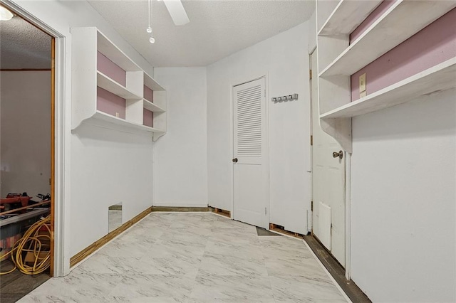 interior space with marble finish floor, a ceiling fan, and visible vents