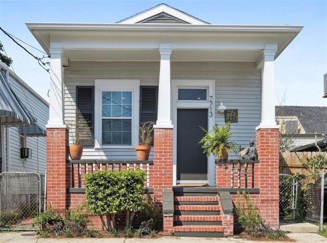 7713 Zimpel St, New Orleans, LA 70118 - view of side of home with covered porch