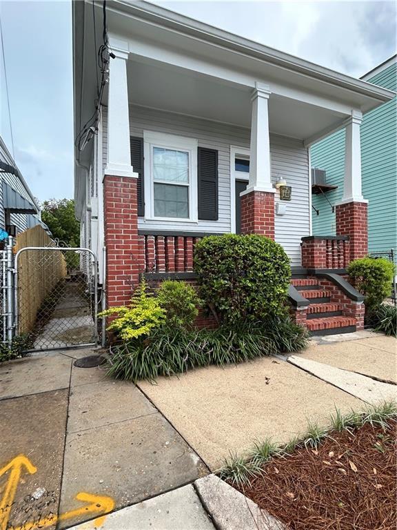 7713 Zimpel St, New Orleans, LA 70118 - view of front of property with brick siding and covered porch