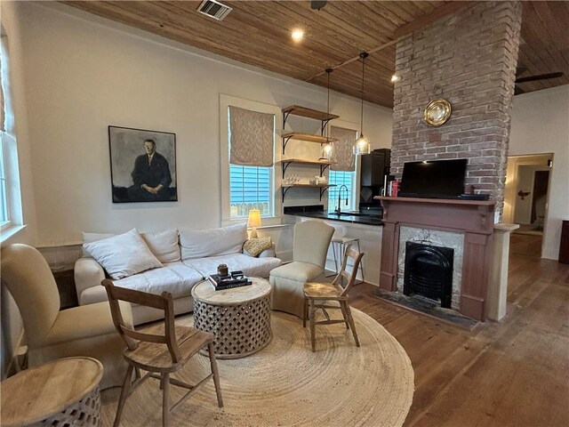 7713 Zimpel St, New Orleans, LA 70118 - living room with wood ceiling, a ceiling fan, hardwood / wood-style flooring, stairs, and a fireplace