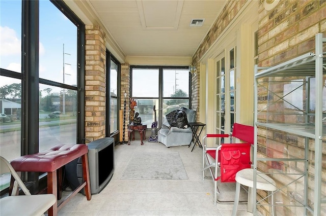3856 Gentilly Dr, New Orleans, LA 70122 - sunroom with tile patterned floors and brick wall