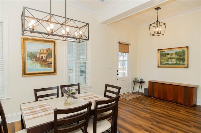 dining room featuring a chandelier, baseboards, ornamental molding, and dark wood finished floors