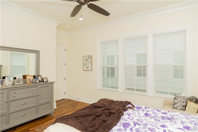 bedroom featuring crown molding, ceiling fan, baseboards, and dark wood finished floors