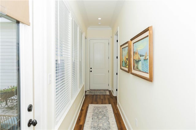 hall with dark wood-type flooring, baseboards, and recessed lighting