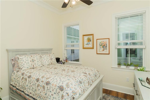 bedroom with dark wood-style flooring, baseboards, ornamental molding, and a ceiling fan