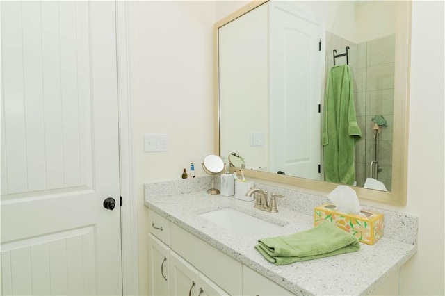 full bath with a stall shower and vanity