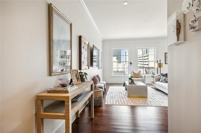 living area with crown molding and wood finished floors