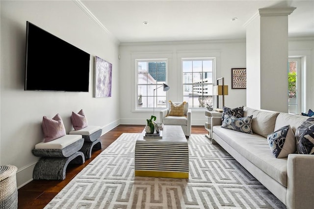 living room with baseboards, crown molding, and wood finished floors