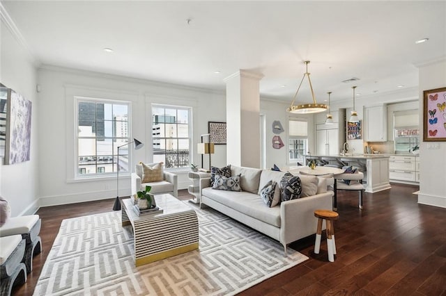 living room featuring baseboards, crown molding, and dark wood finished floors