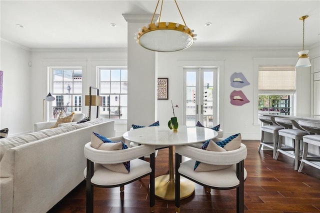 dining space featuring french doors, ornamental molding, and dark wood finished floors