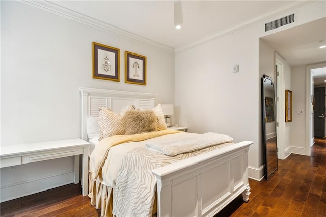 bedroom featuring dark wood-type flooring, visible vents, baseboards, and ornamental molding