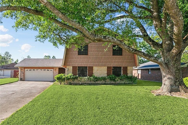 106 Somerset Rd, La Place, LA 70068 - split level home with a front yard, an attached garage, brick siding, and concrete driveway